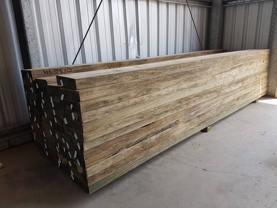 A Stack Of Wooden Beams Sitting On Top Of Each Other In A Warehouse — Cooroy Landscape Supplies And Garden Centre In Eumundi, QLD