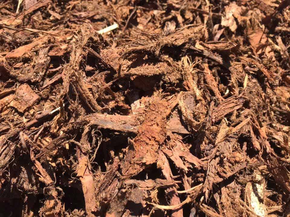 A Pile Of Brown Mulch Is Sitting On The Ground — Cooroy Landscape Supplies and Garden Centre in Noosa, QLD