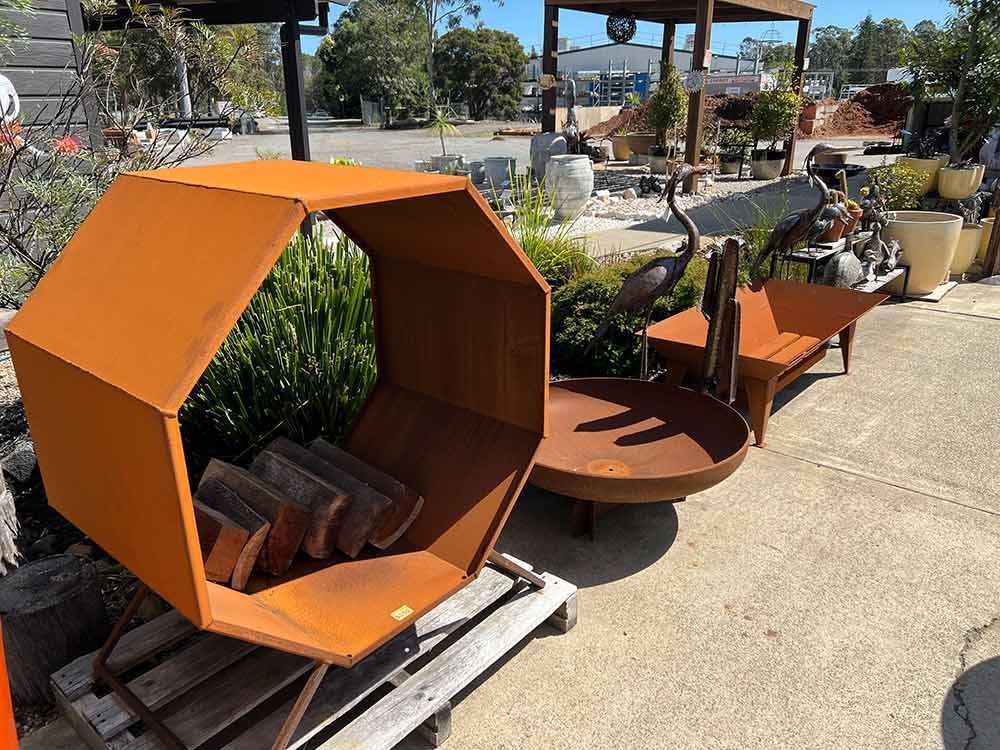 A Fire Pit Is Sitting On Top Of A Wooden Pallet — Cooroy Landscape Supplies and Garden Centre in Noosa, QLD