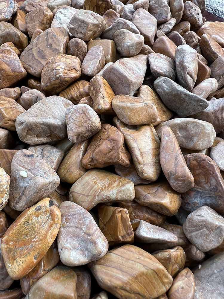 A Pile Of Pebbles Sitting On Top Of Each Other On A Table — Cooroy Landscape Supplies and Garden Centre in Noosa, QLD