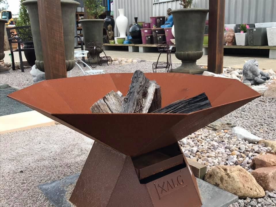 A Fire Pit With A Lot Of Wood In It — Cooroy Landscape Supplies and Garden Centre in Eumundi, QLD