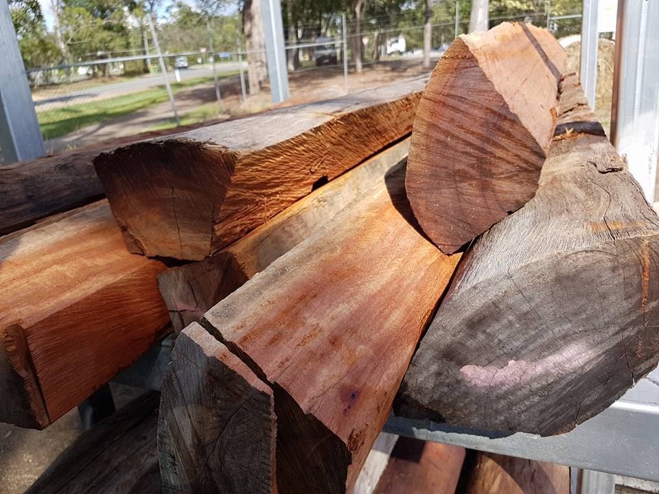 A Pile of Logs Sitting on Top of Each Other on A Metal Rack — Cooroy Landscape Supplies and Garden Centre in Cooroy, QLD