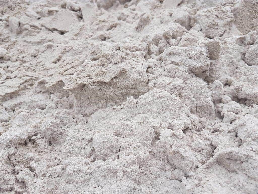 A Pile Of White Sand Is Sitting On The Ground — Cooroy Landscape Supplies and Garden Centre in Gympie, QLD