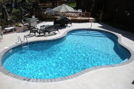 inground pool surrounded by patio furniture