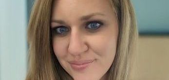 A close up of a woman 's face with a smile on her face.