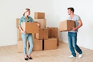 Couple Holding The Boxes — Moving in Wyandotte, MI