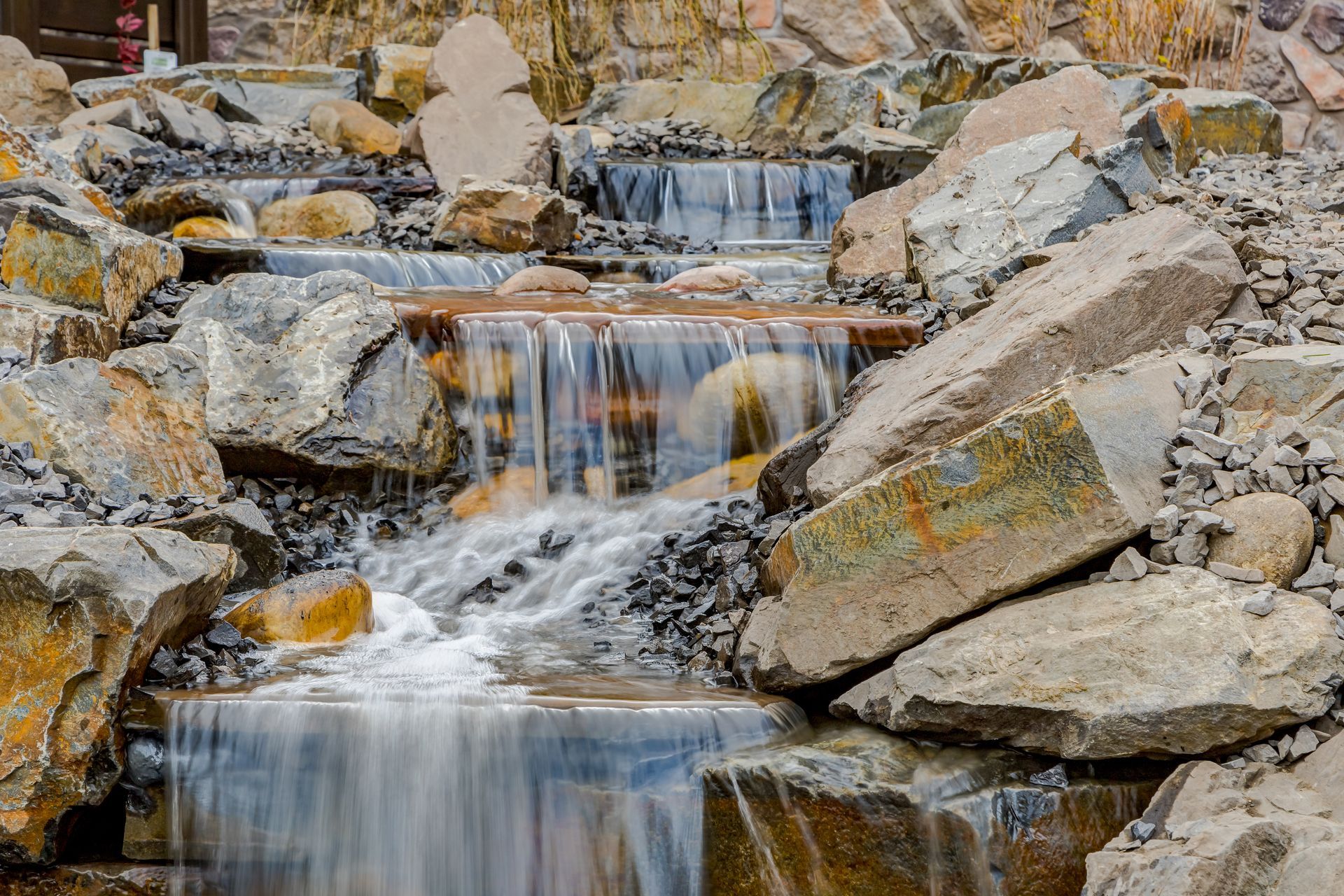 A waterfall is surrounded by rocks and is surrounded by rocks.