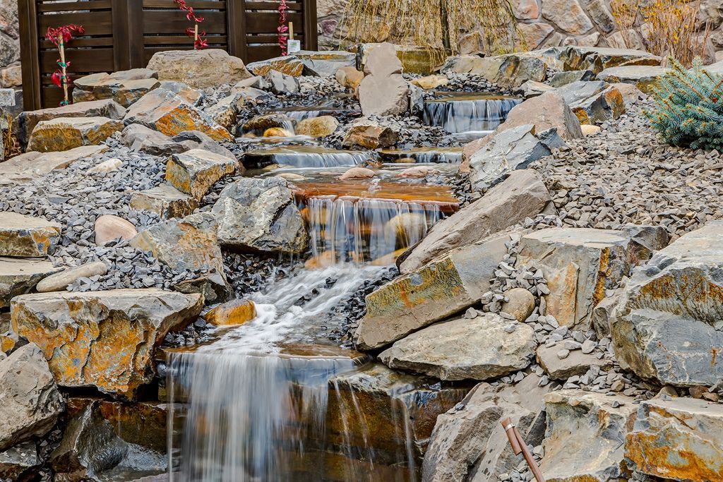 Small waterfall cascading over layered rocks.