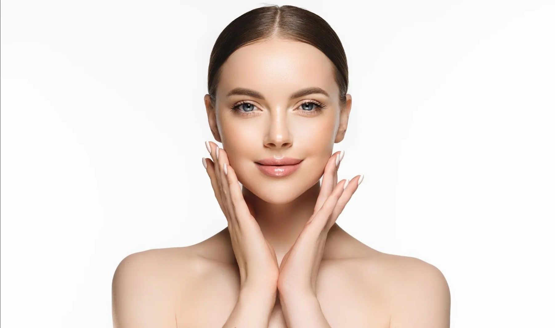 A woman is getting a facial treatment at a spa.