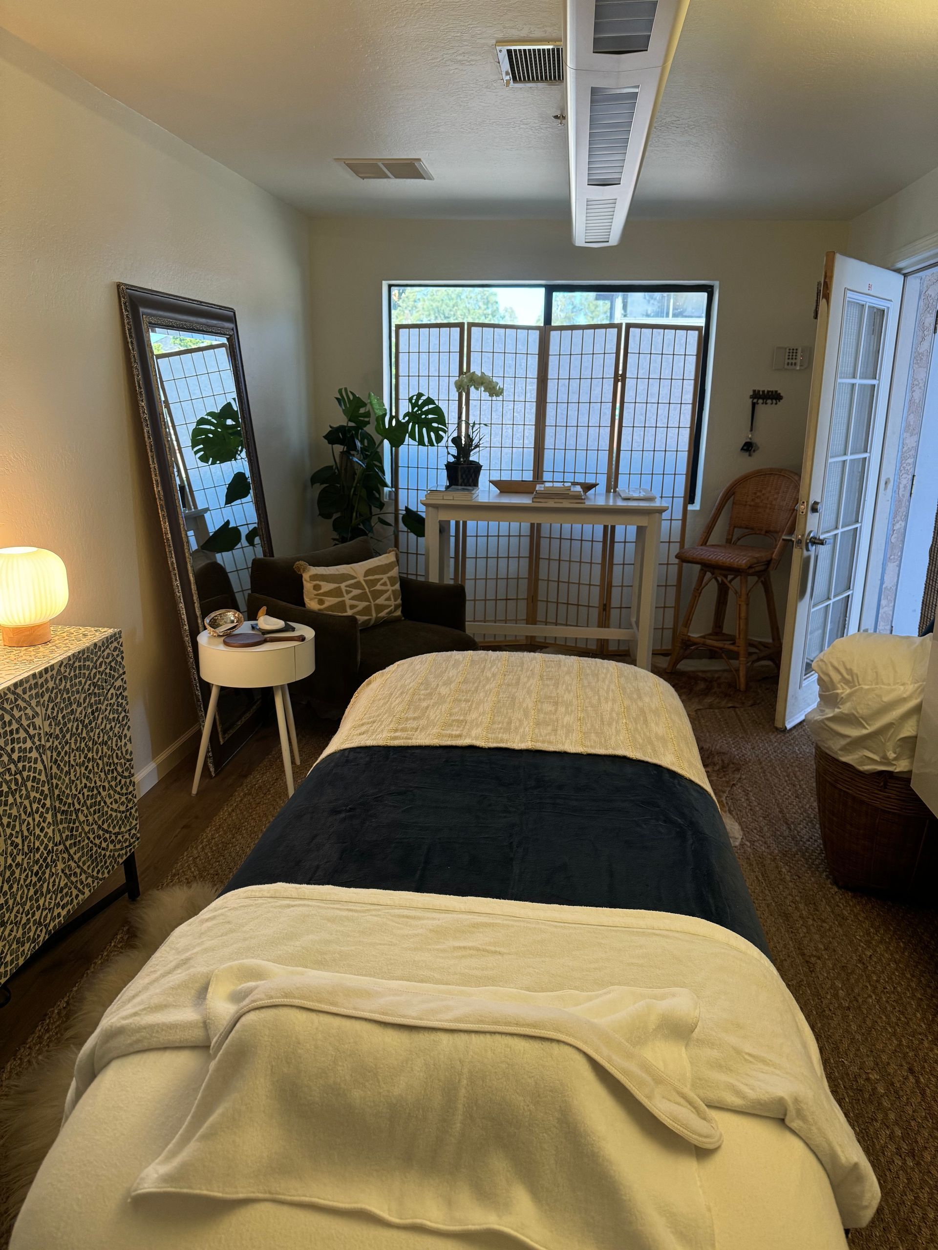 There is a massage table in the middle of the room.