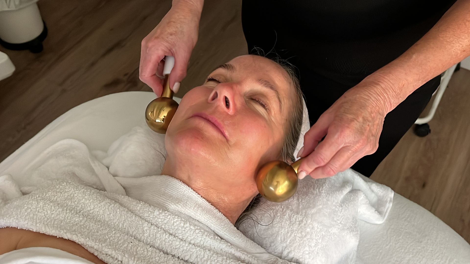 A woman is getting a facial treatment at a spa.