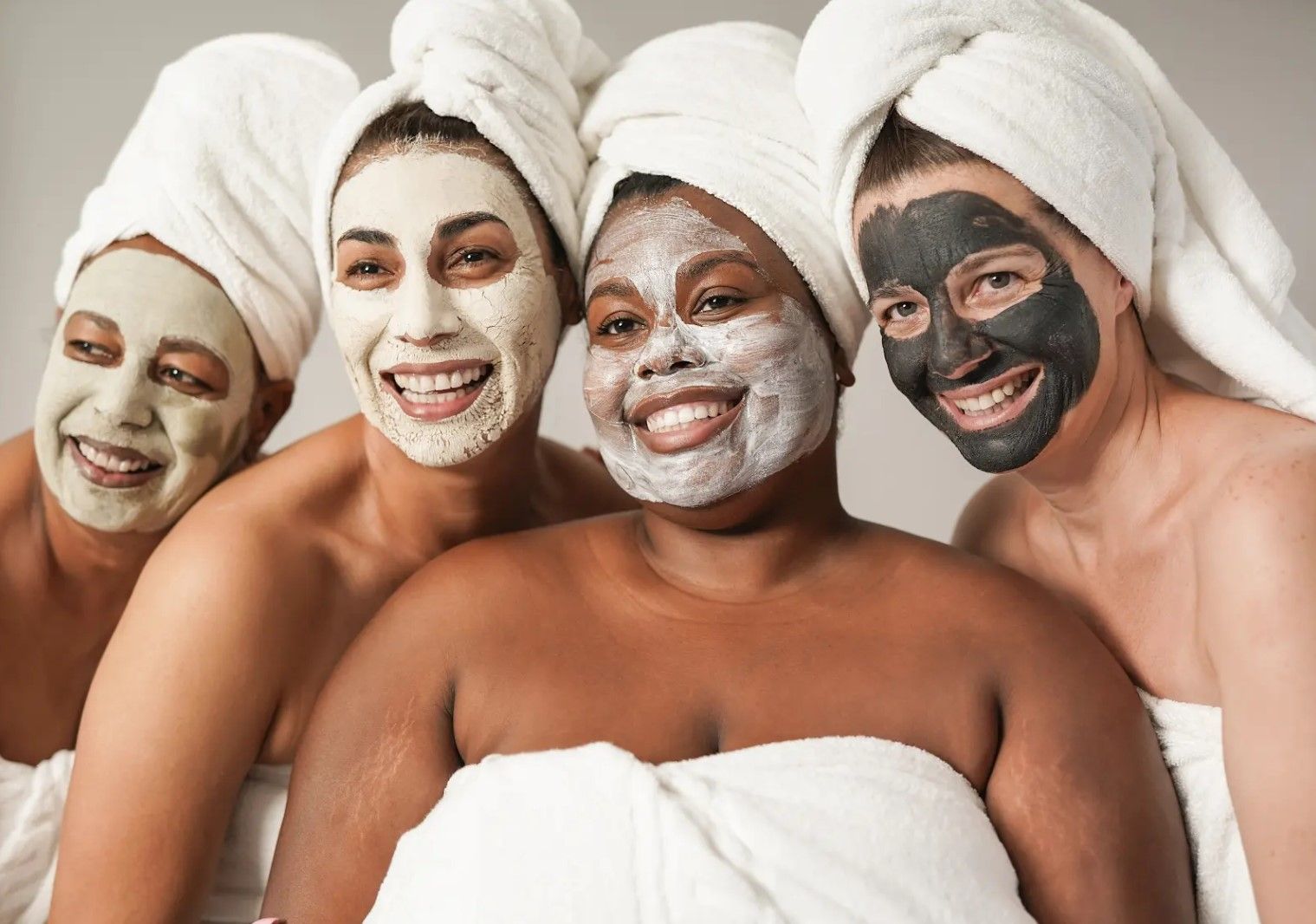 A group of women with towels wrapped around their heads and face masks.
