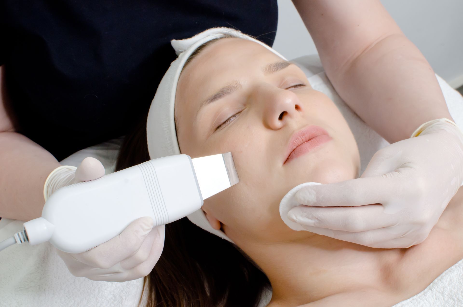 A woman is getting a facial treatment at a beauty salon.