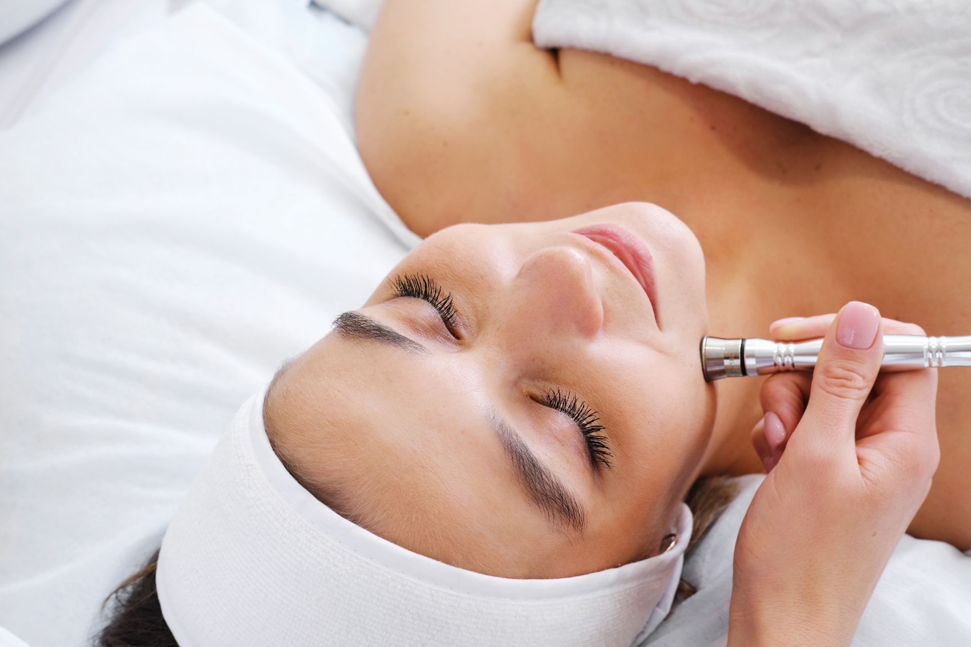 A woman is getting a facial treatment at a spa.