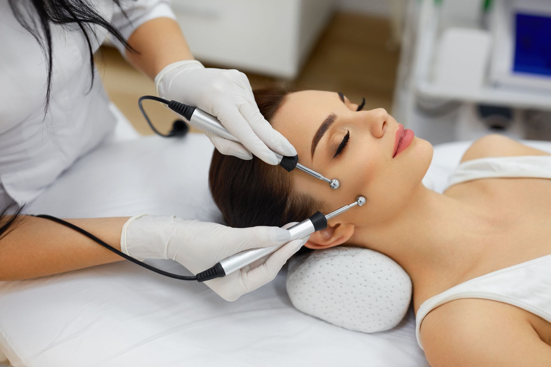A woman is getting a facial treatment at a beauty salon.