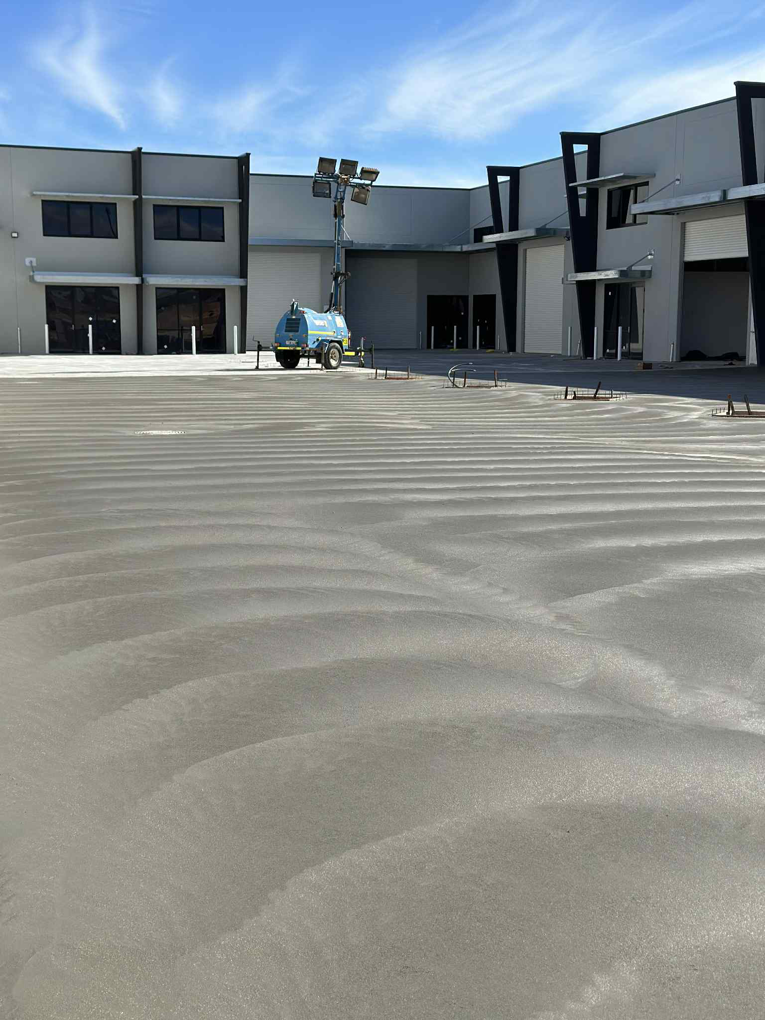 Grey concrete commercial carpark with brush finish