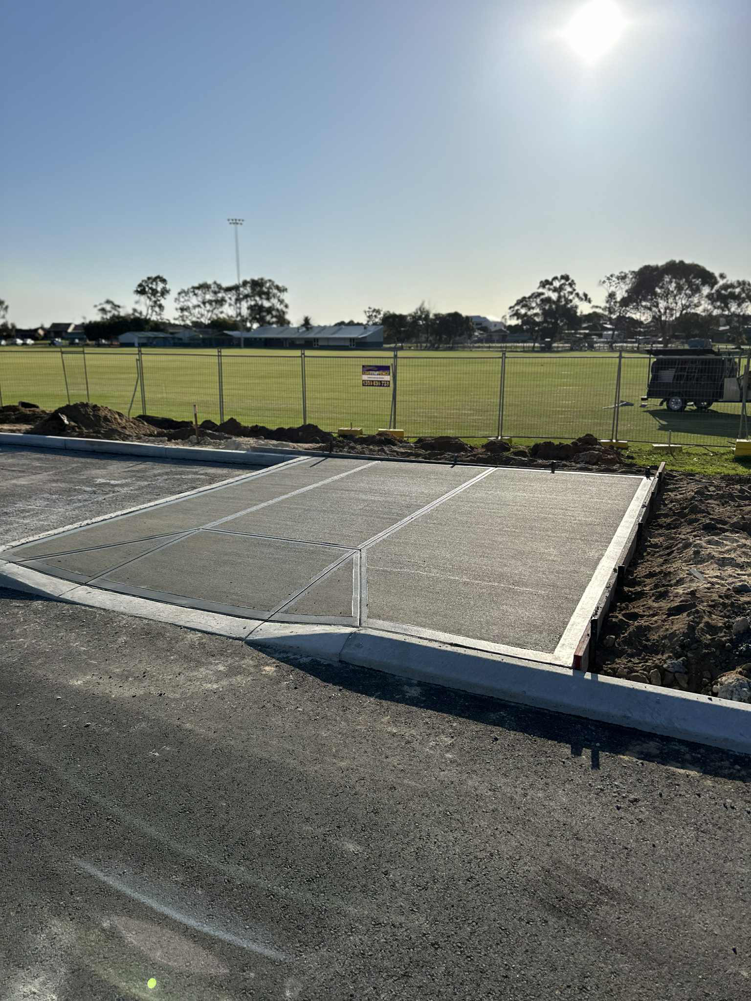 standard grey concrete bus stop near oval in Perth