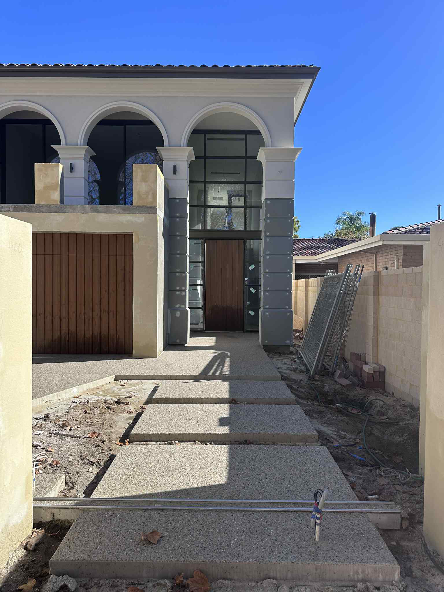 Coral concrete mix exposed aggregate stepping stones leading to amazing Perth homes front door