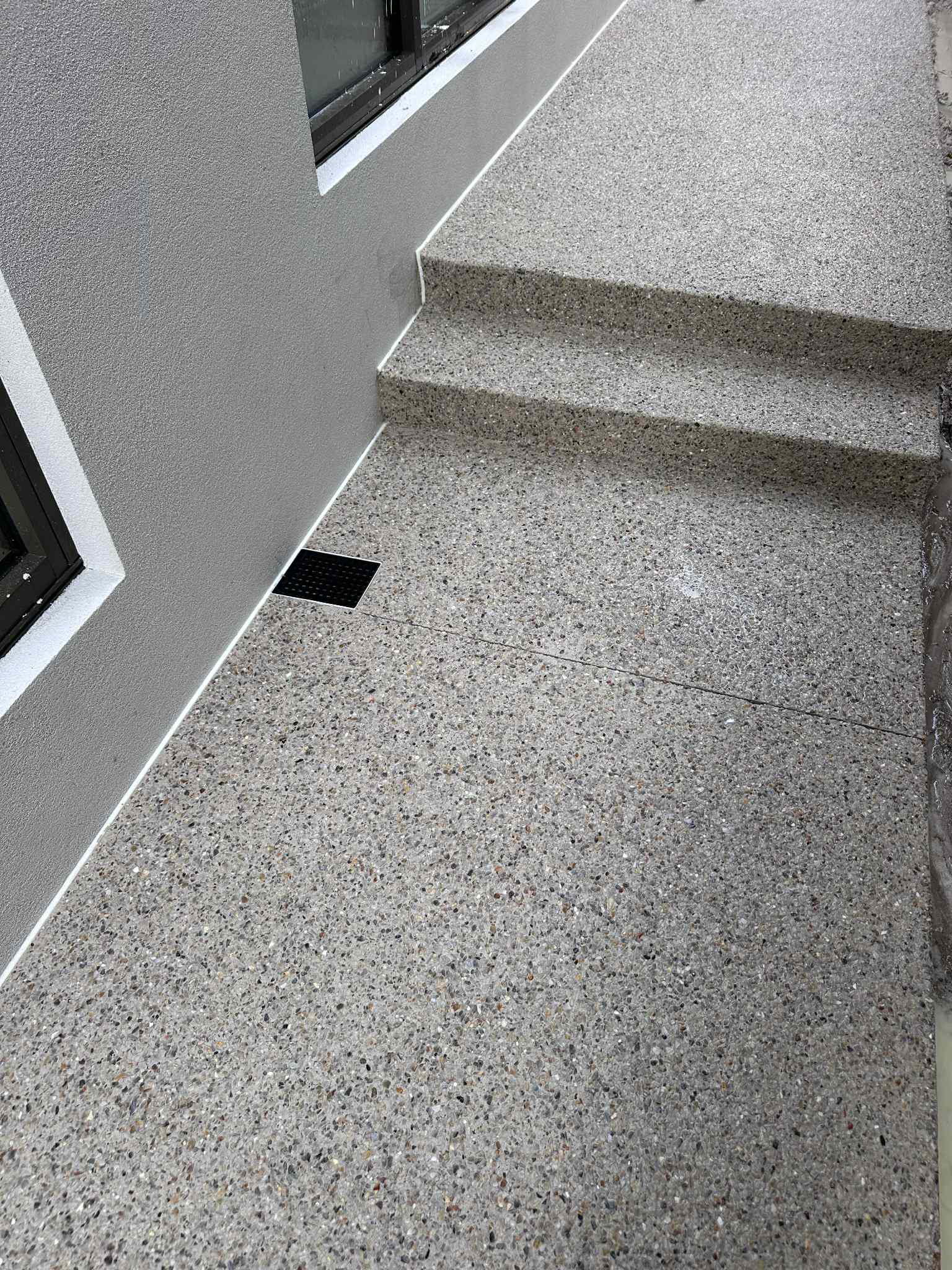 Small set of steps down the side of a perth home in exposed aggregate grey