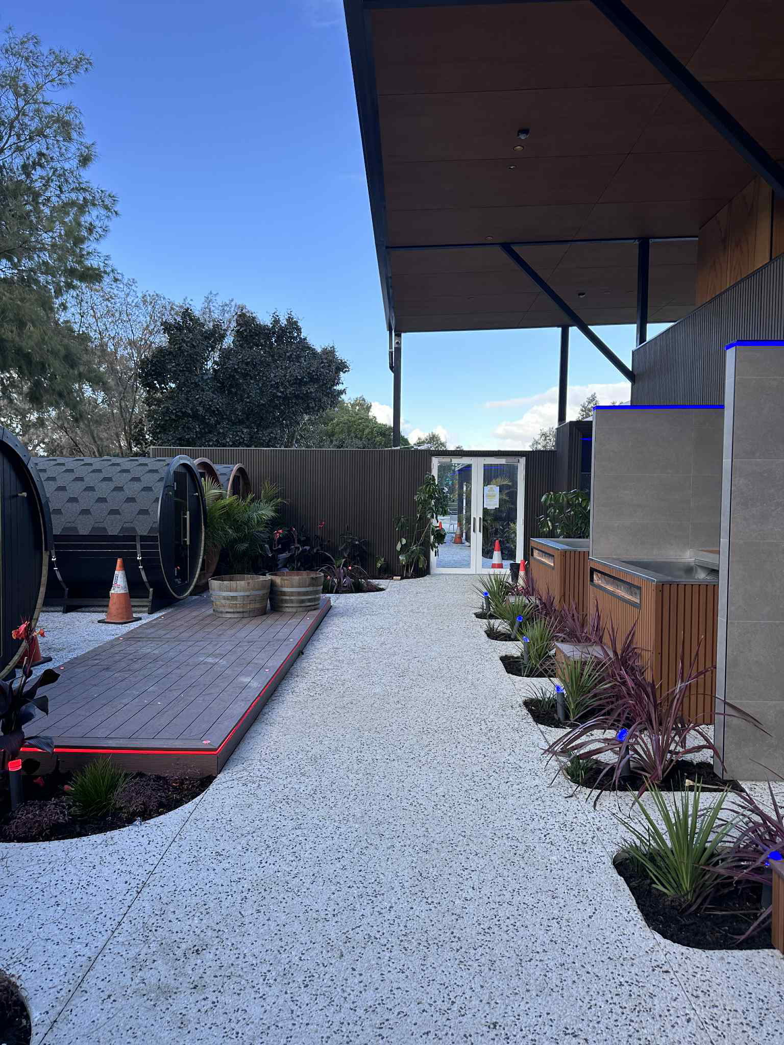 Exposed aggregate pathway leading to gym and sauna