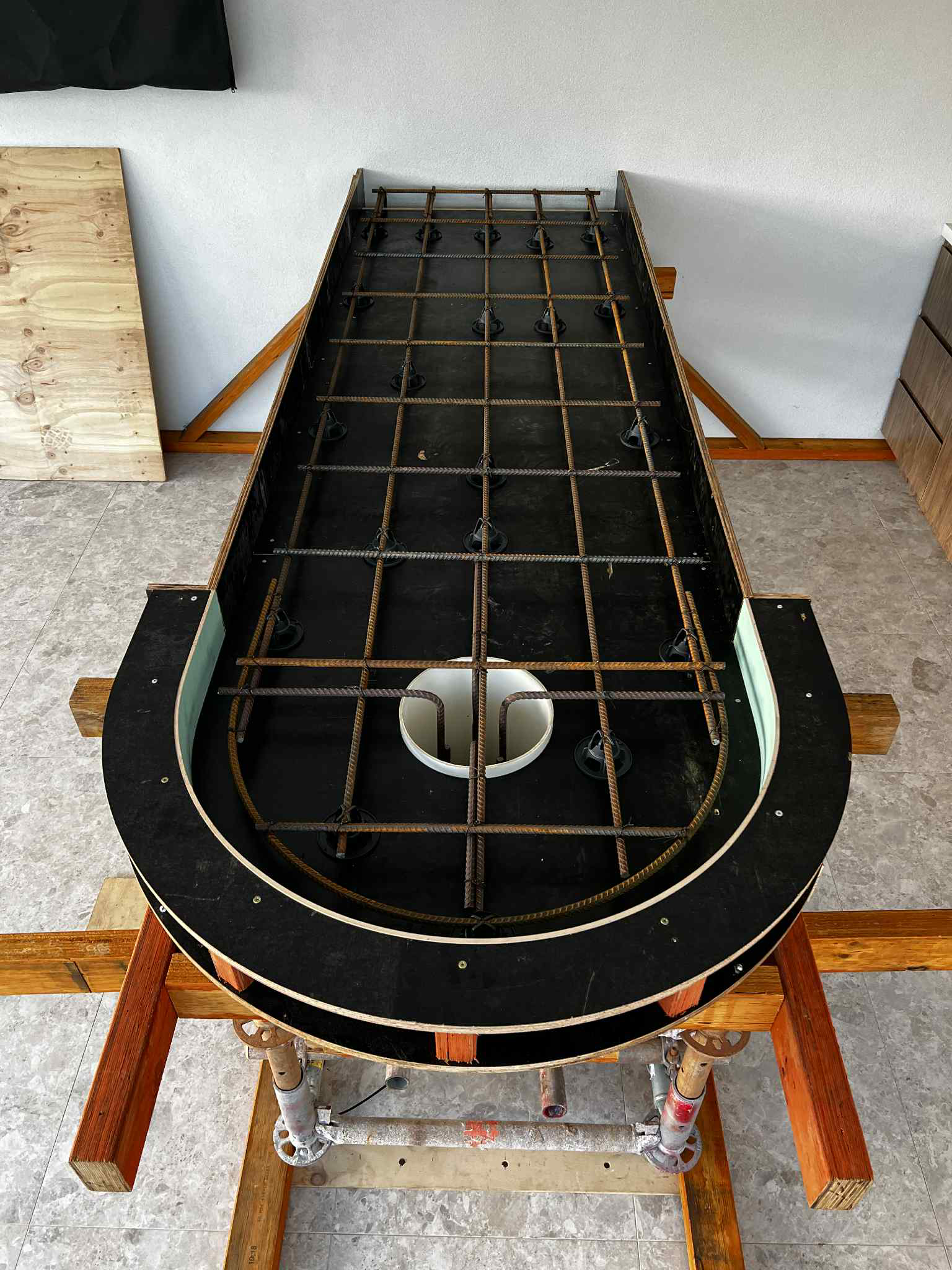 Formwork for concrete countertop in outdoor kitchen with curved end.