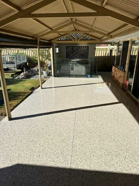 Honed aggregate concrete patio installed by Woodlands Construct.