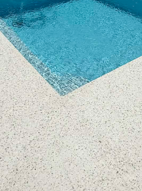Honed conrete pool surrounds with crystal clear pool water in Gwelup poured by Woodlands Construct