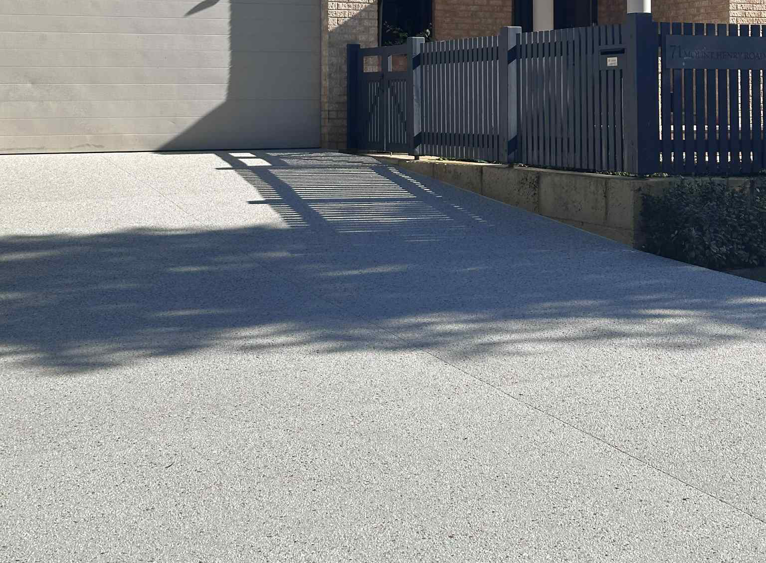 Exposed aggregate driveway in Perth after concrete sealing.