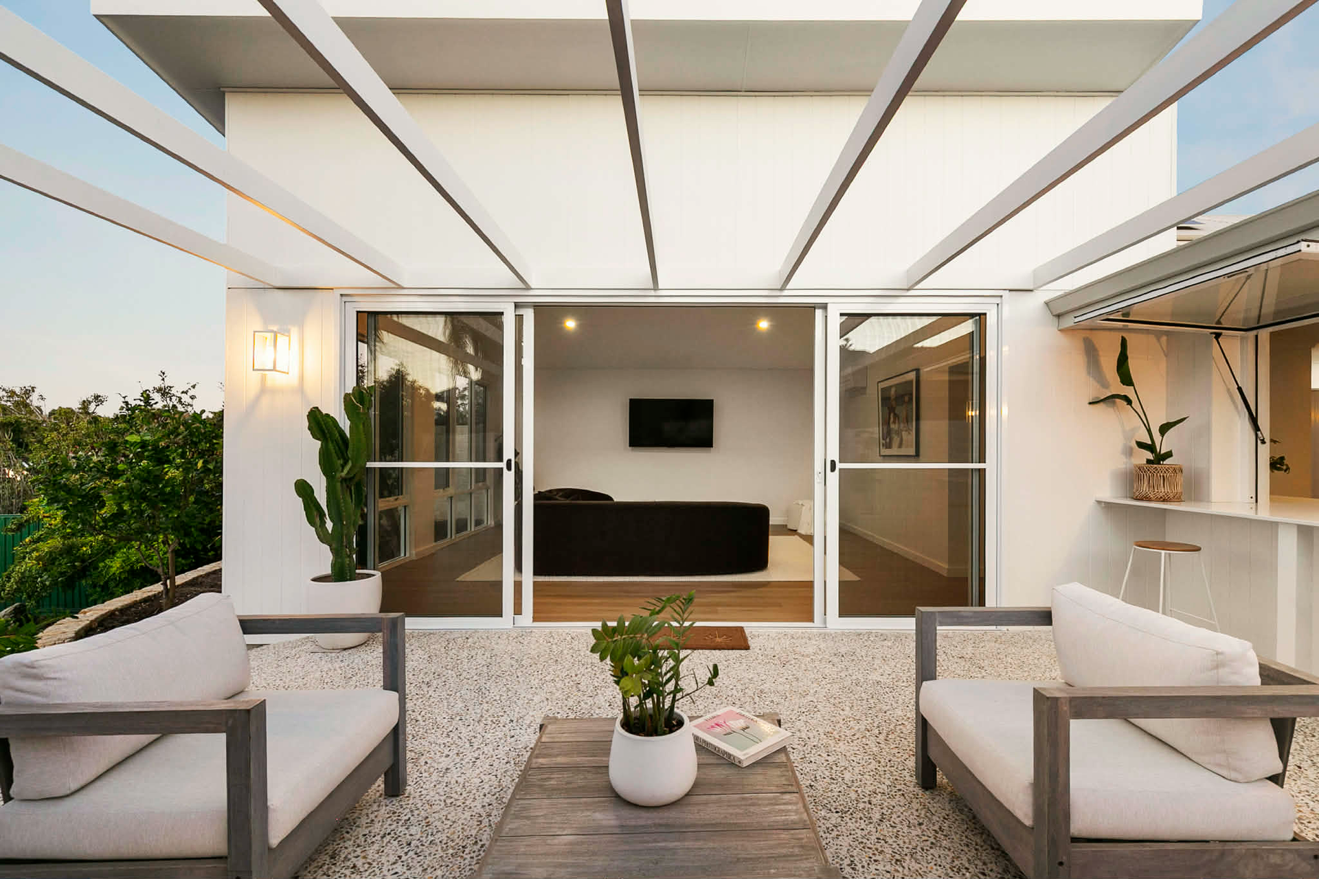 Exposed aggregate alfresco area in North Beach using Geostone Holcim Wattle White mix, creating a bright modern outdoor living space.