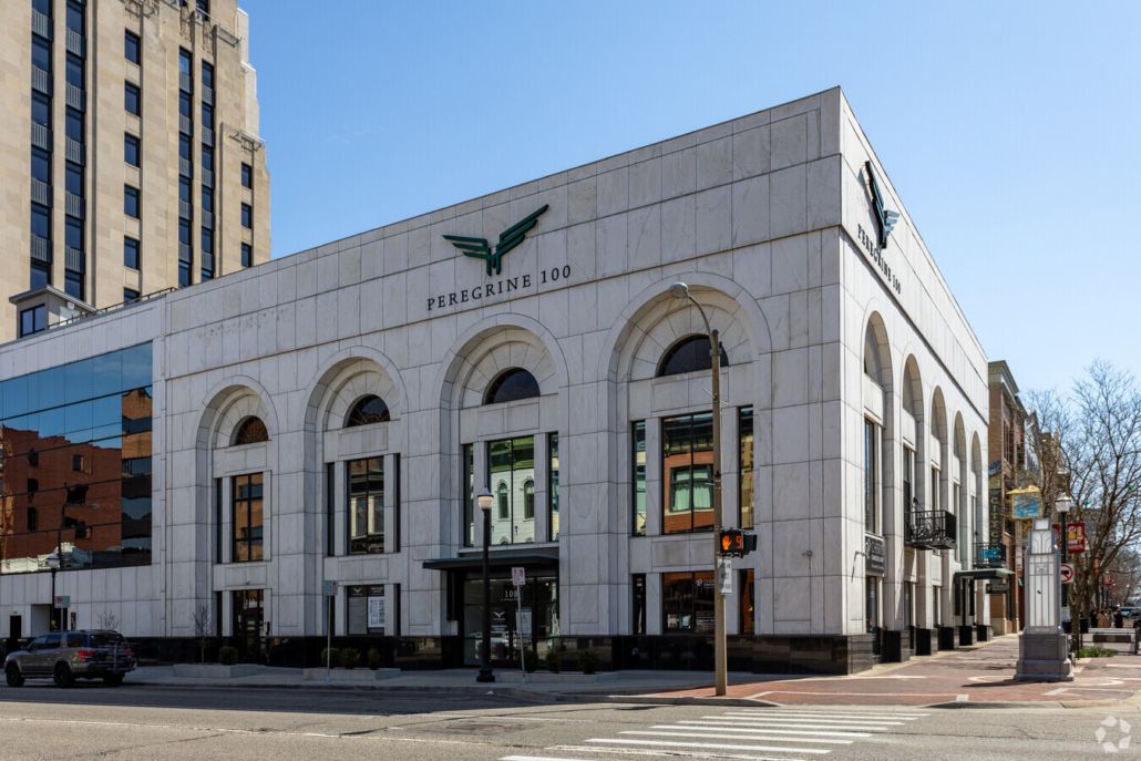 A large white building with a green eagle on the side of it