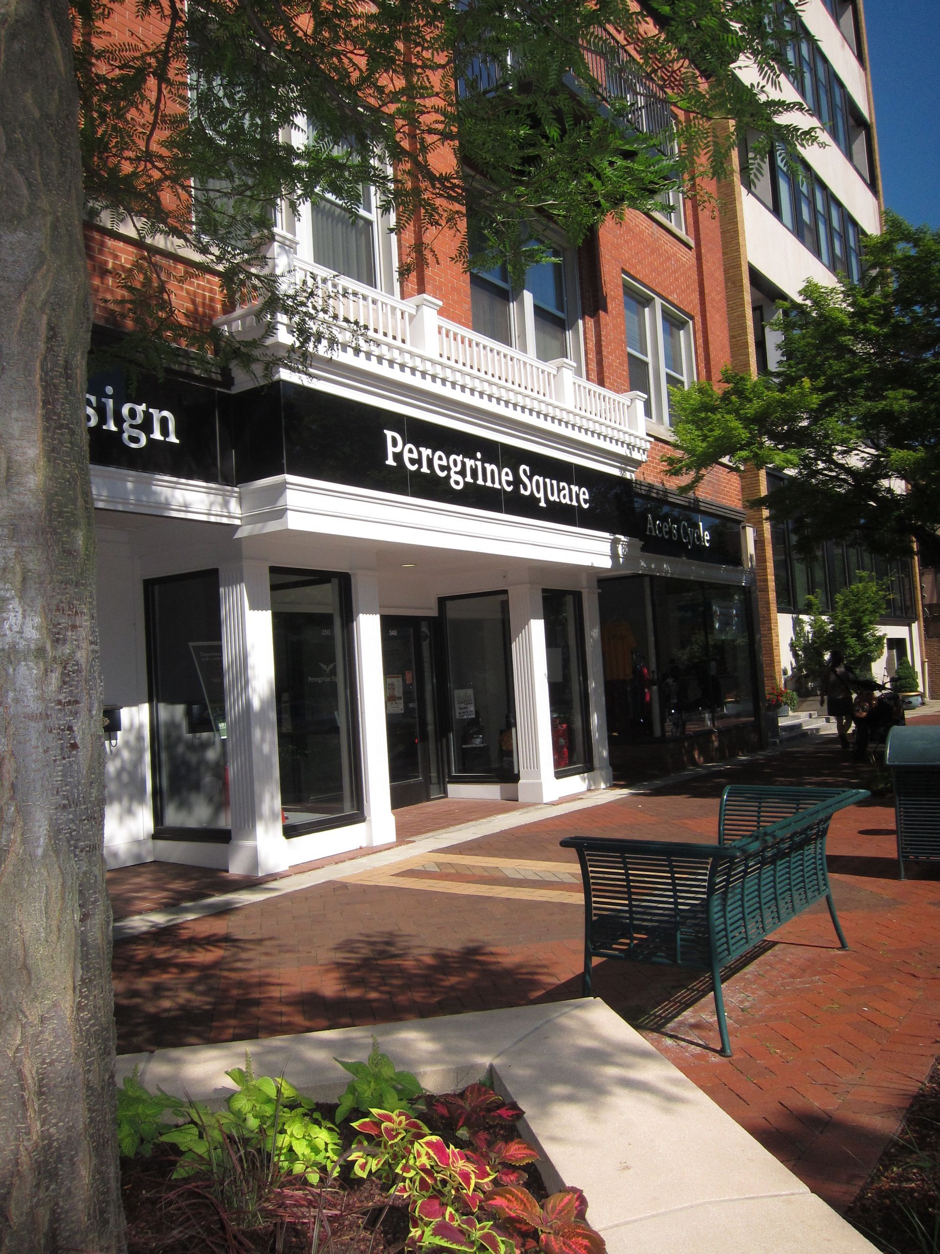 A brick building with a sign that says peregrine square