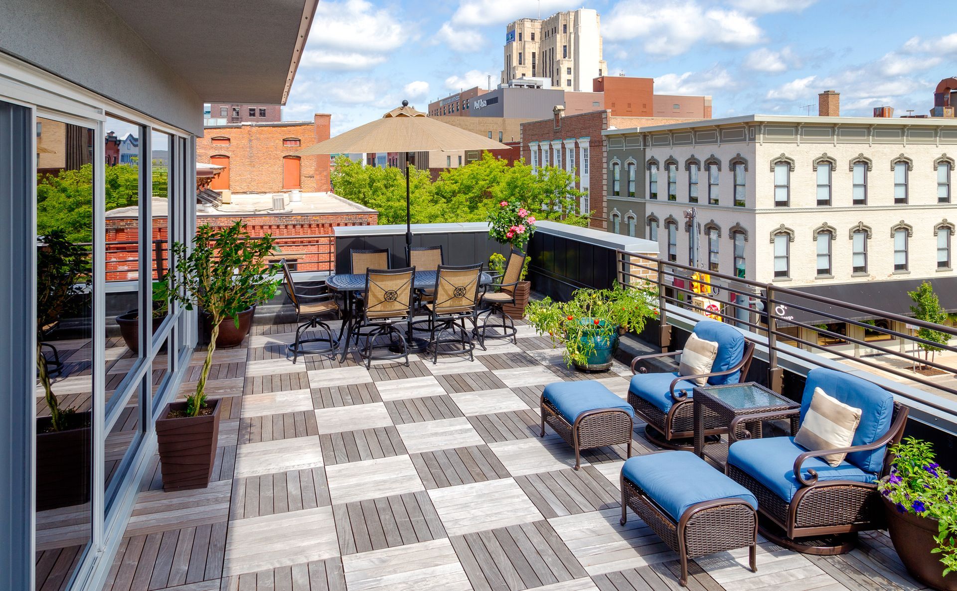 A rooftop deck with a checkered floor and a table and chairs