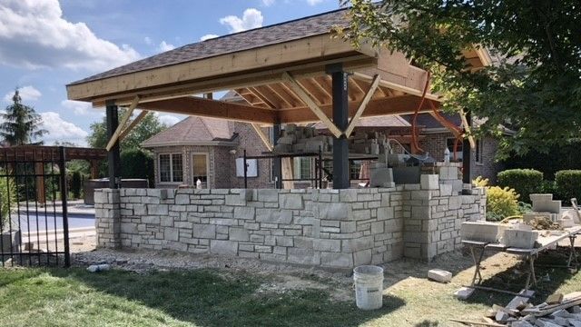 Outside backyard custom stone building near pool in Frankfort