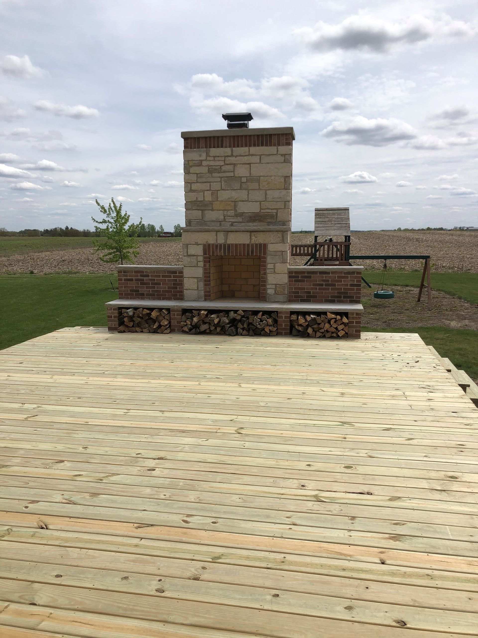 Outdoor Fireplace Complete on a Deck — Monee, IL — Custom Brick & Stone