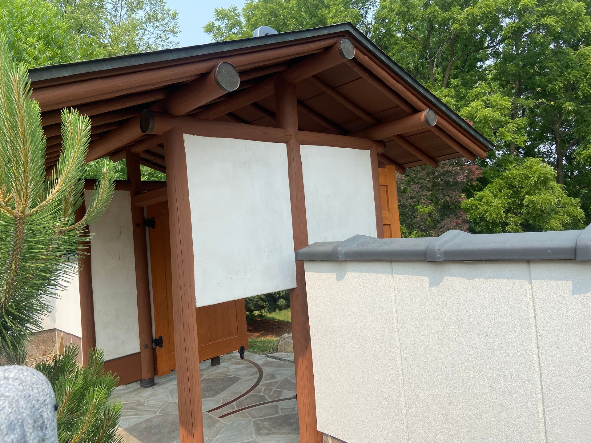 A building with a wooden roof and a white wall