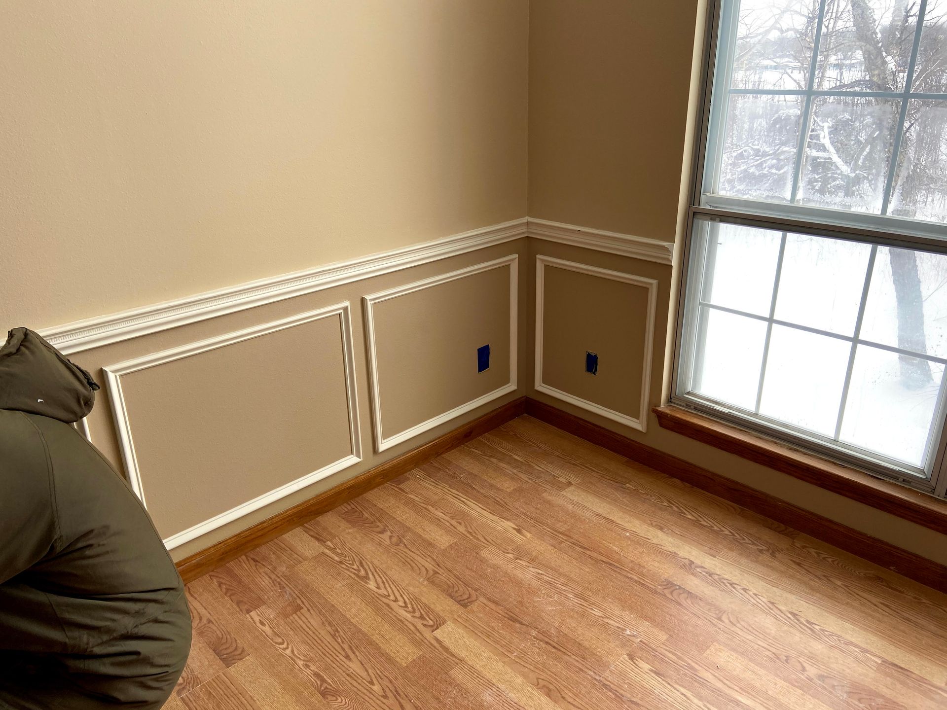 A room with a wooden floor and a window.