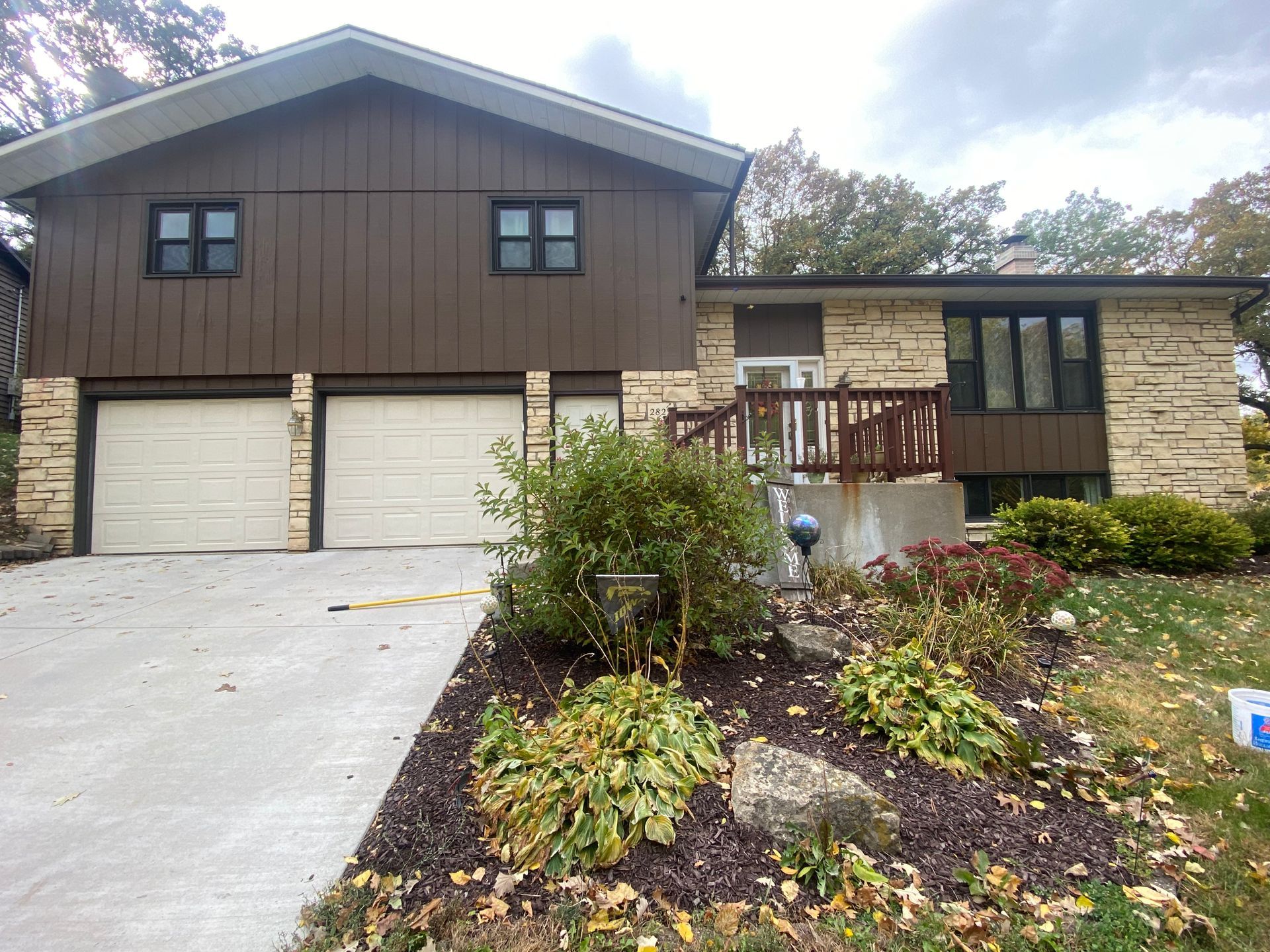 A large house with two garage doors and a deck