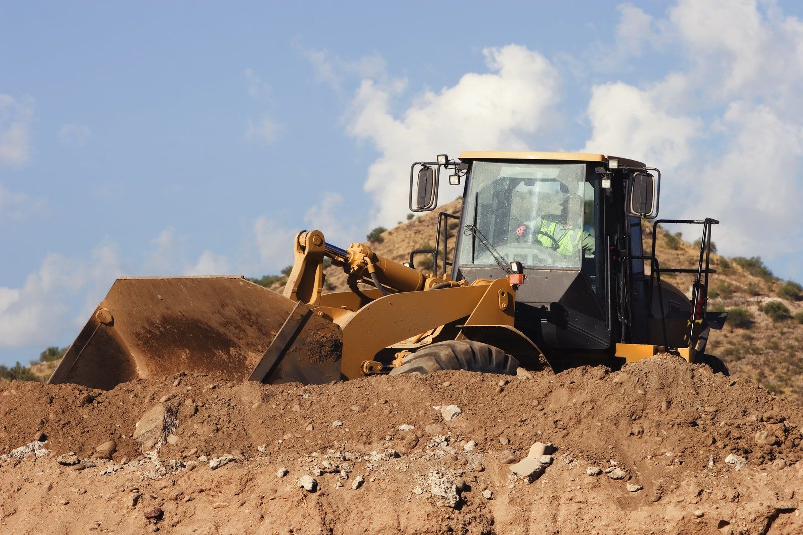worker driving the excavator