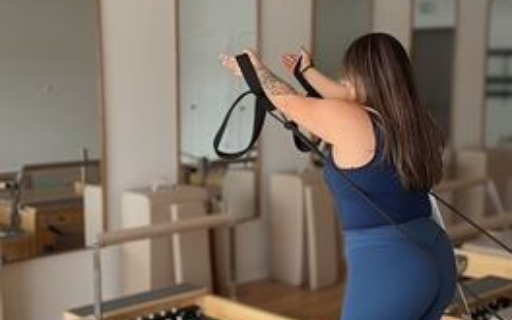 People doing yoga in a studio with raised arms.