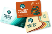 Three Tabletop Enclave gift cards in orange, teal, and beige with the company logo and