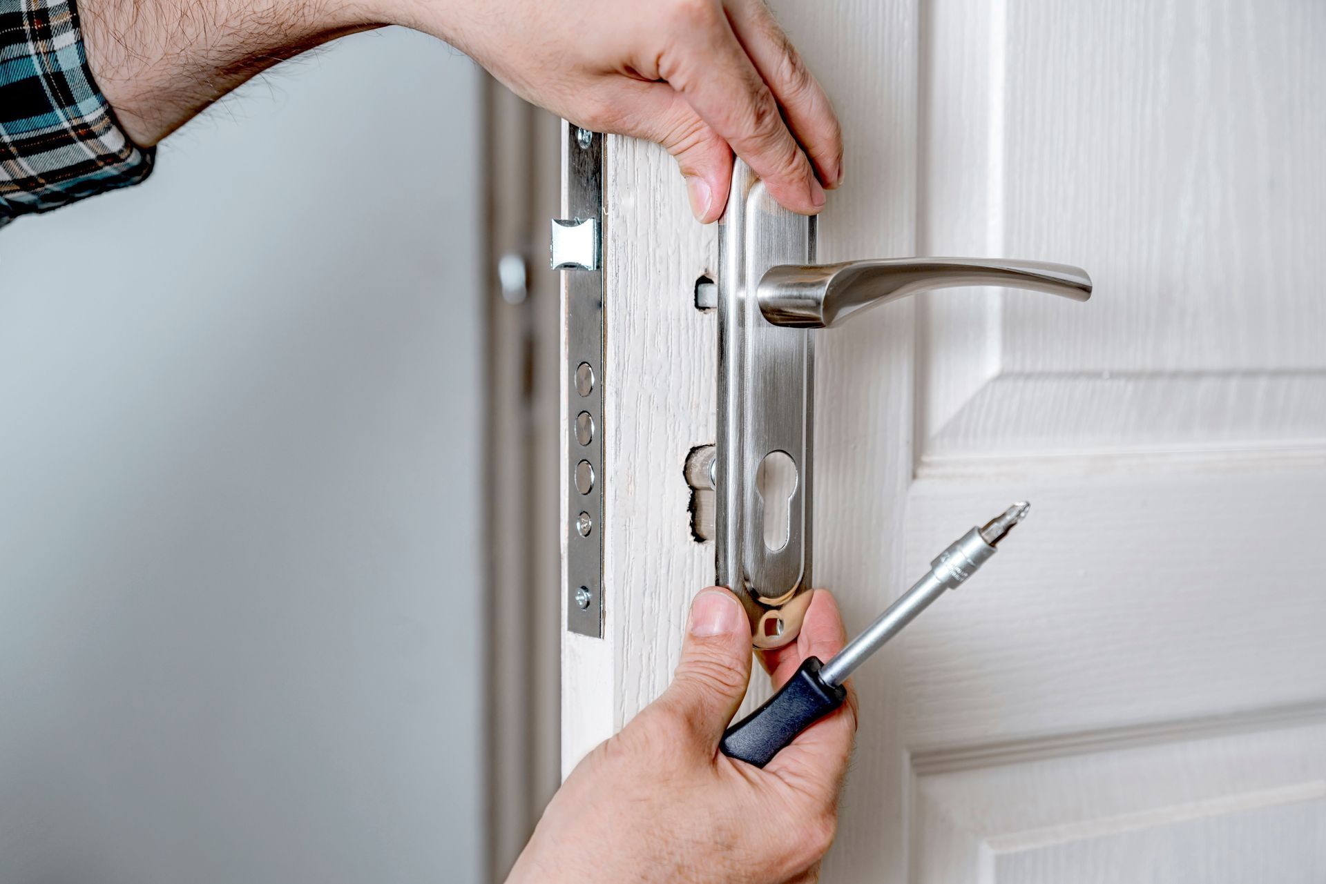A man is installing a door lock.