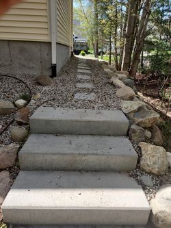 A set of concrete steps leading up to a house.