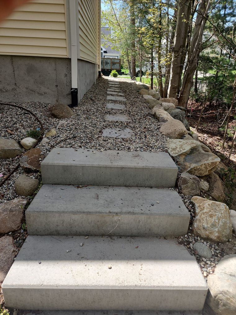 A set of concrete steps leading up to a house.