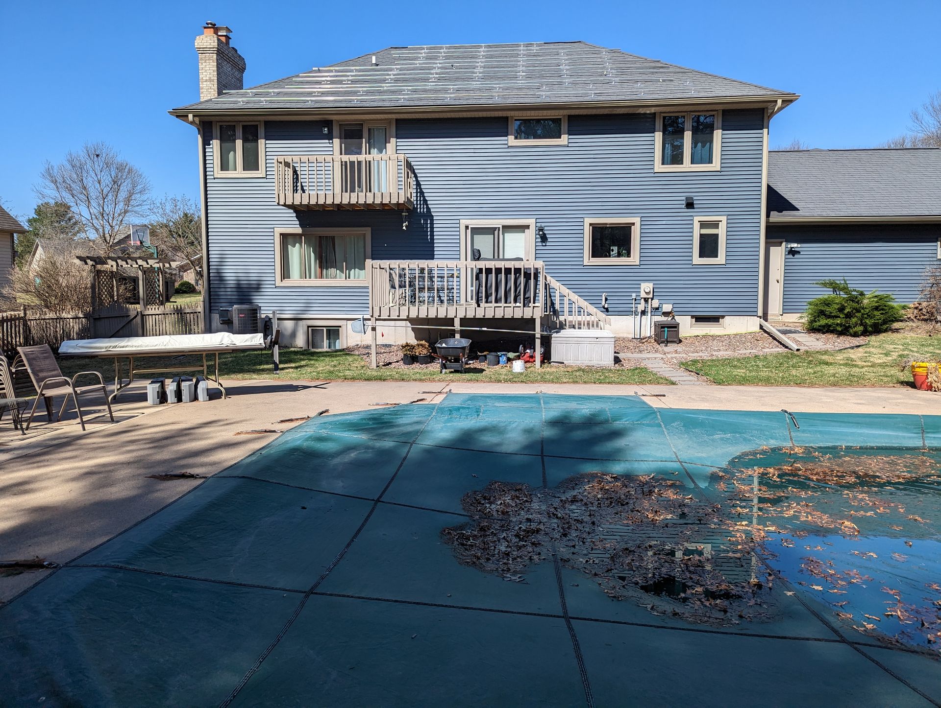 A large house with a swimming pool in front of it