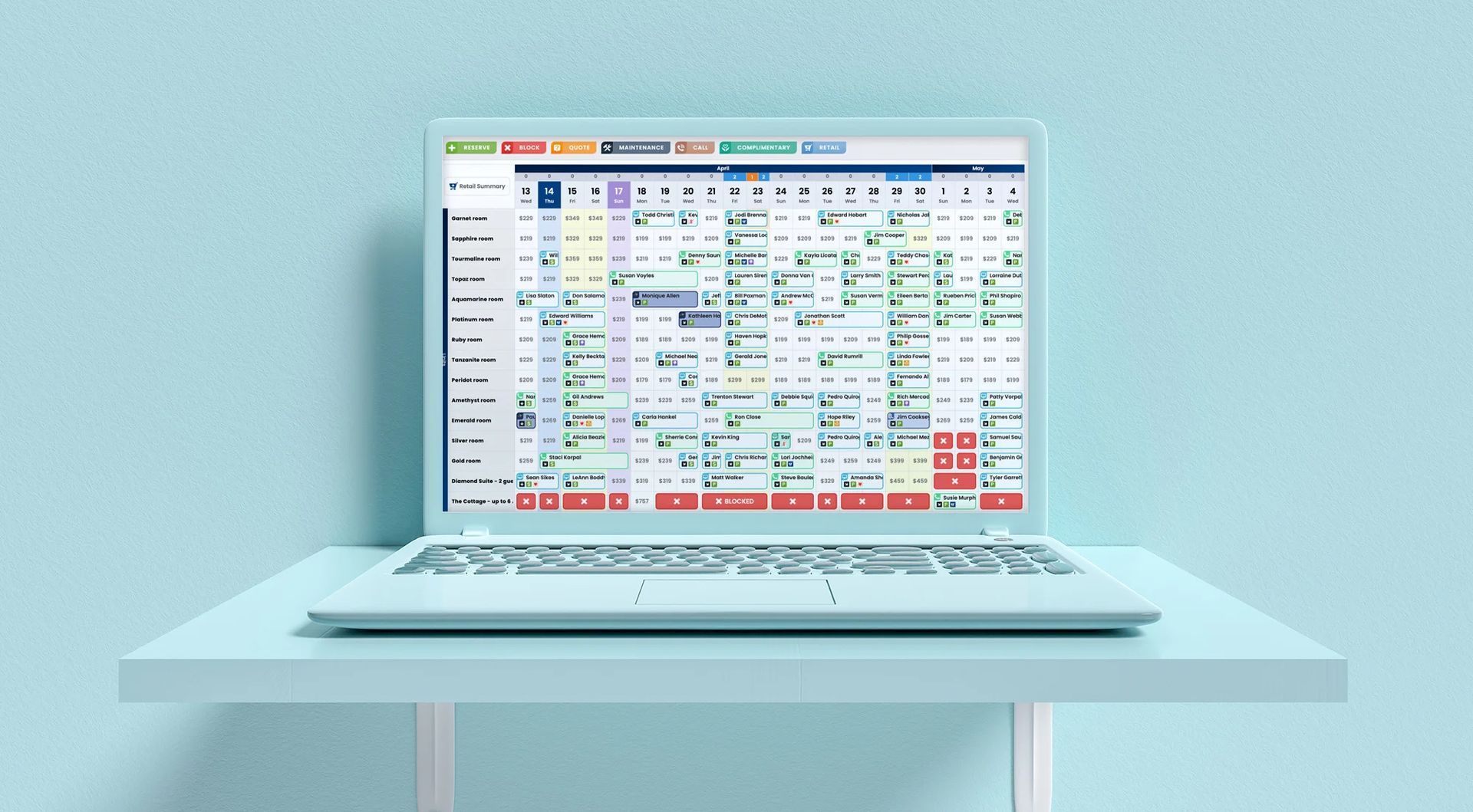 A laptop computer is sitting on a table with a blue background.
