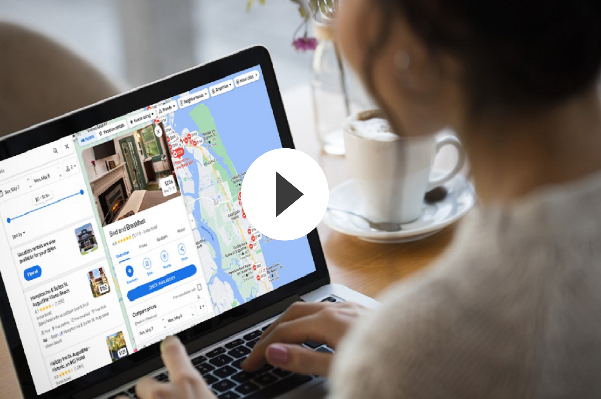 A man is standing in front of a video of a woman pointing at a credit card.
