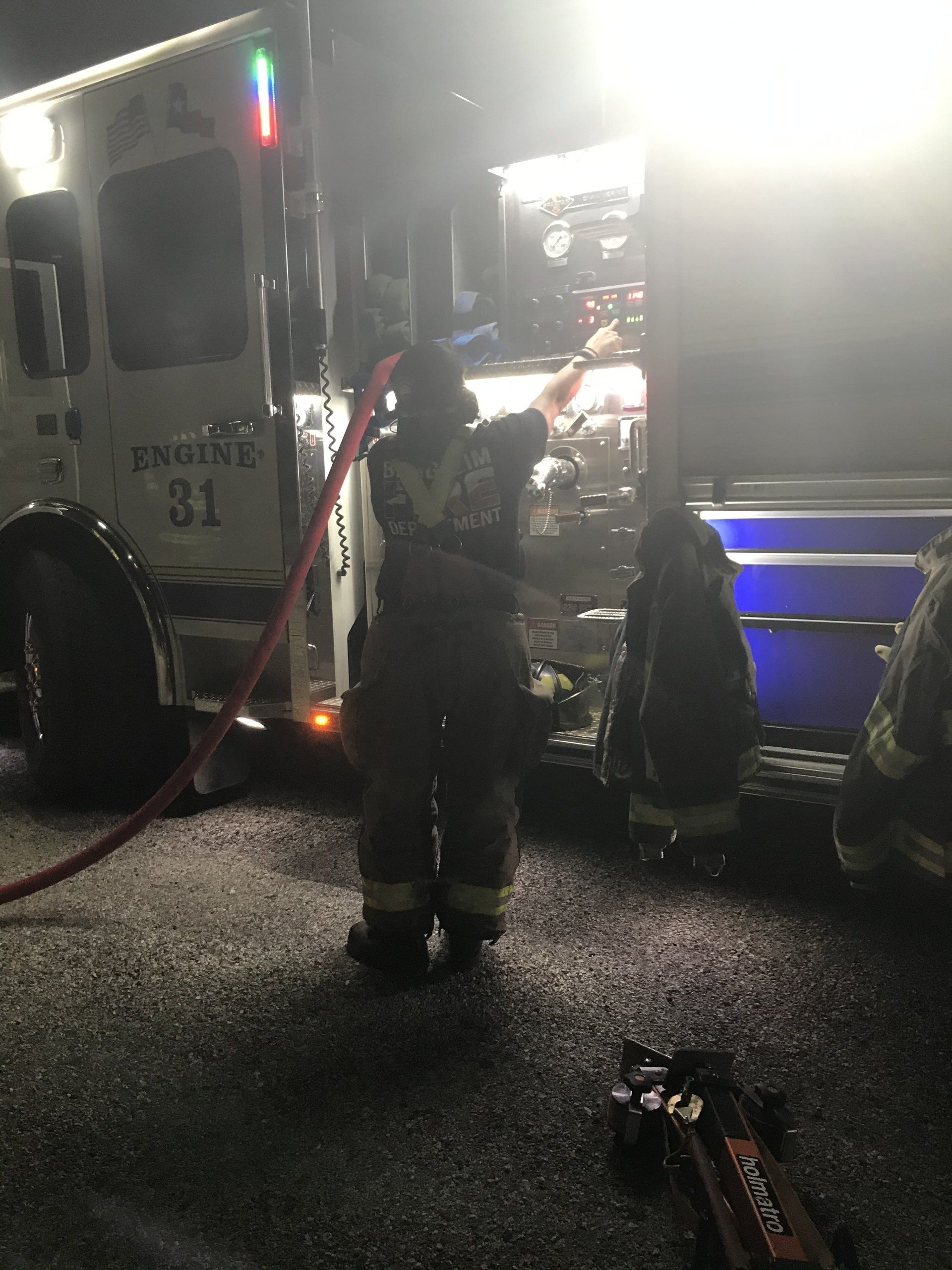 A fireman is standing in front of Bergheim VFD fire engine 31 during a training exercise.