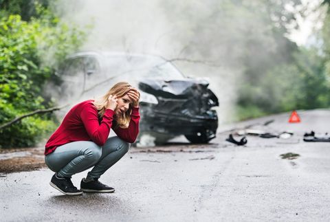 Immigration Attorney — Woman Making A Phone Call By The Damaged Car in Salem, OR