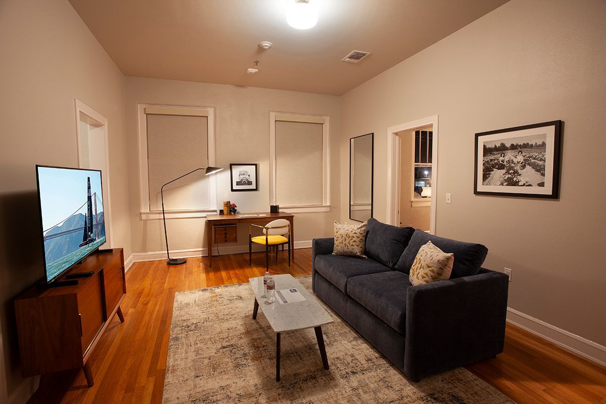A living room with a couch , coffee table , and television.