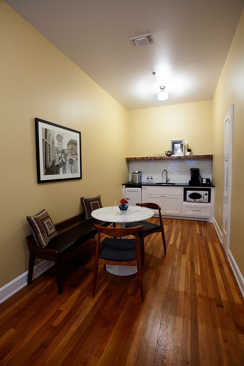 A room with a table and chairs and a bench